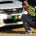Michigan fan Harley Venema, of Fla., places a Michigan sticker on a Michigan State fan's car parked in a tailgate section outside of Raymond James Stadium before the start of the Outback Bowl in Tampa, Fla. on Tuesday, Jan. 1. Melanie Maxwell I AnnArbor.com